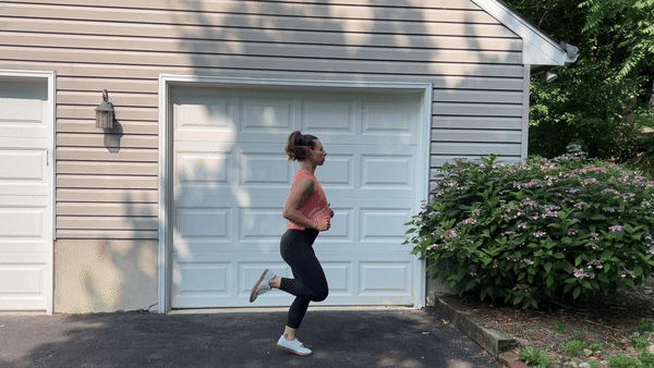 trainer doing butt kicks outside in front of garage